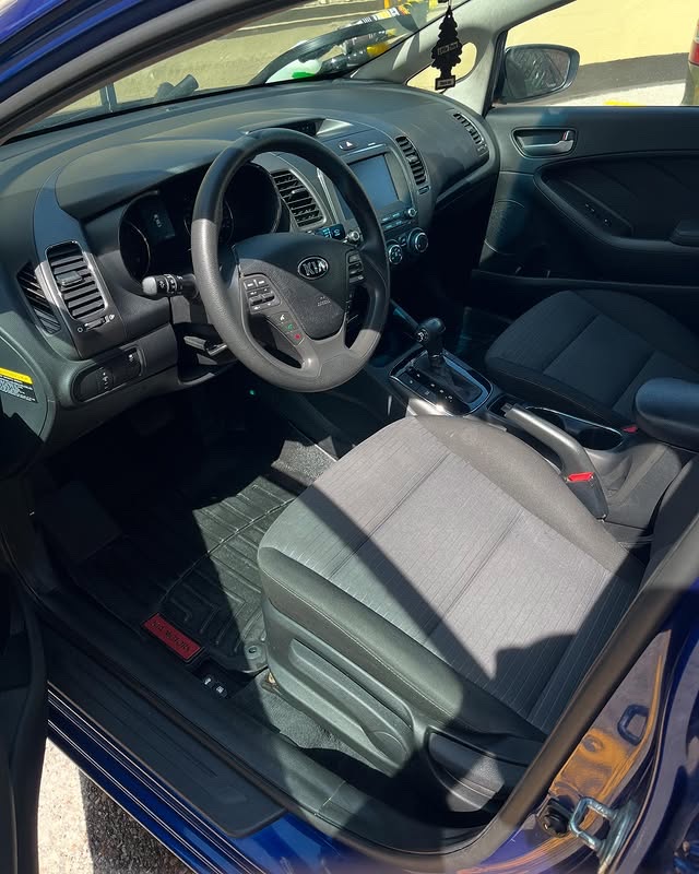 After: Clean Kia Forte driver side with pristine carpet and dashboard